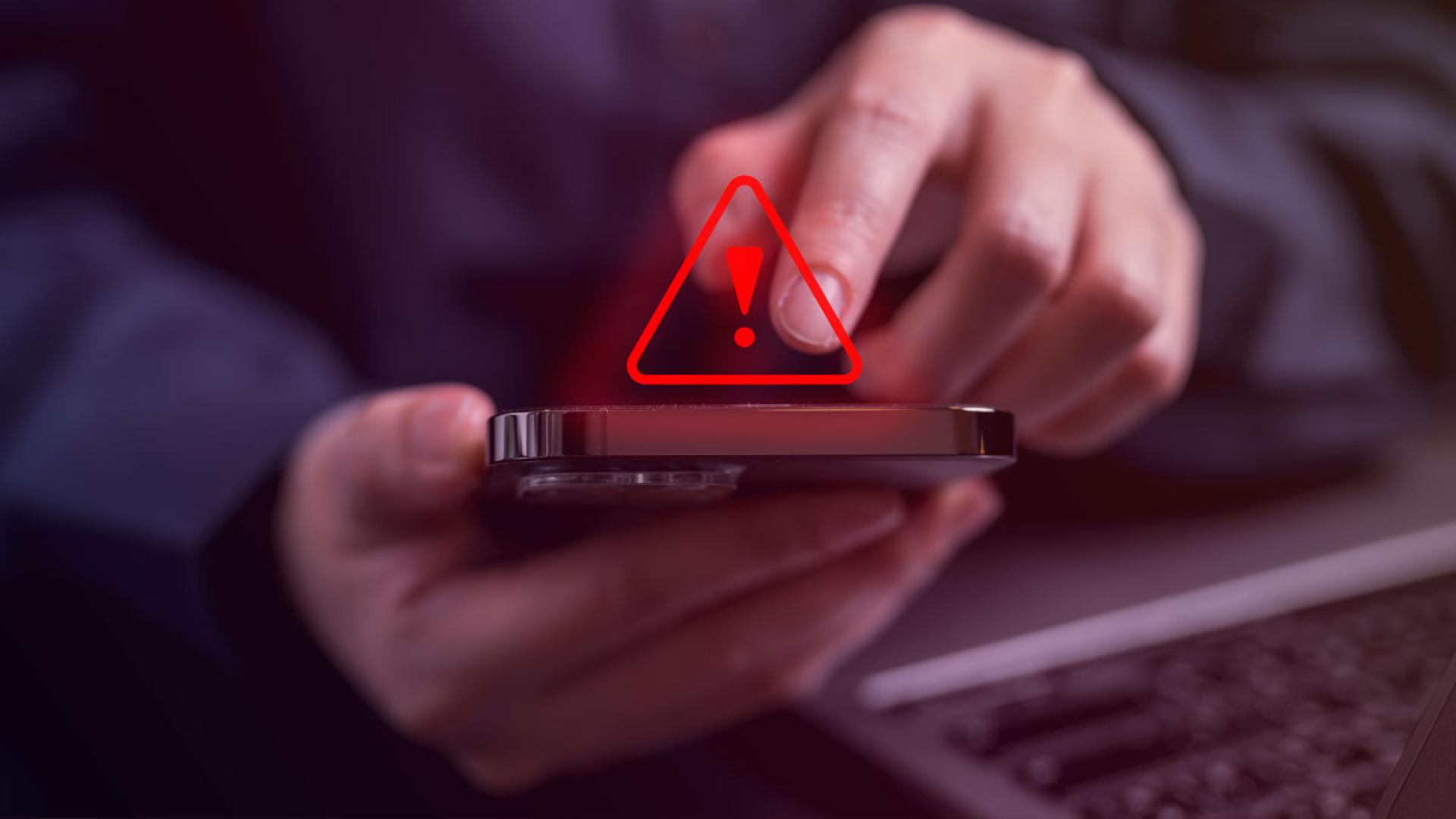 Warning icon above a phone screen