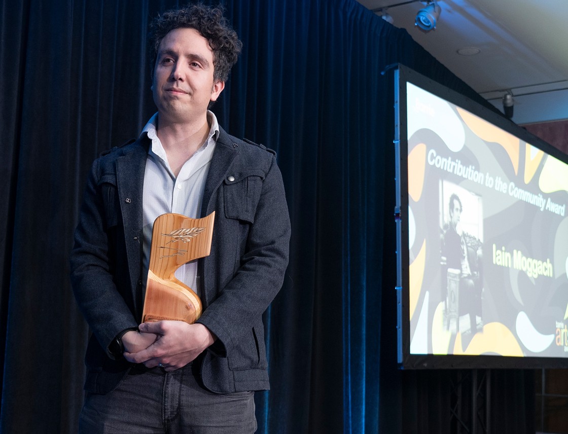 Barrie Arts Award recipient holding the 2024 statuette