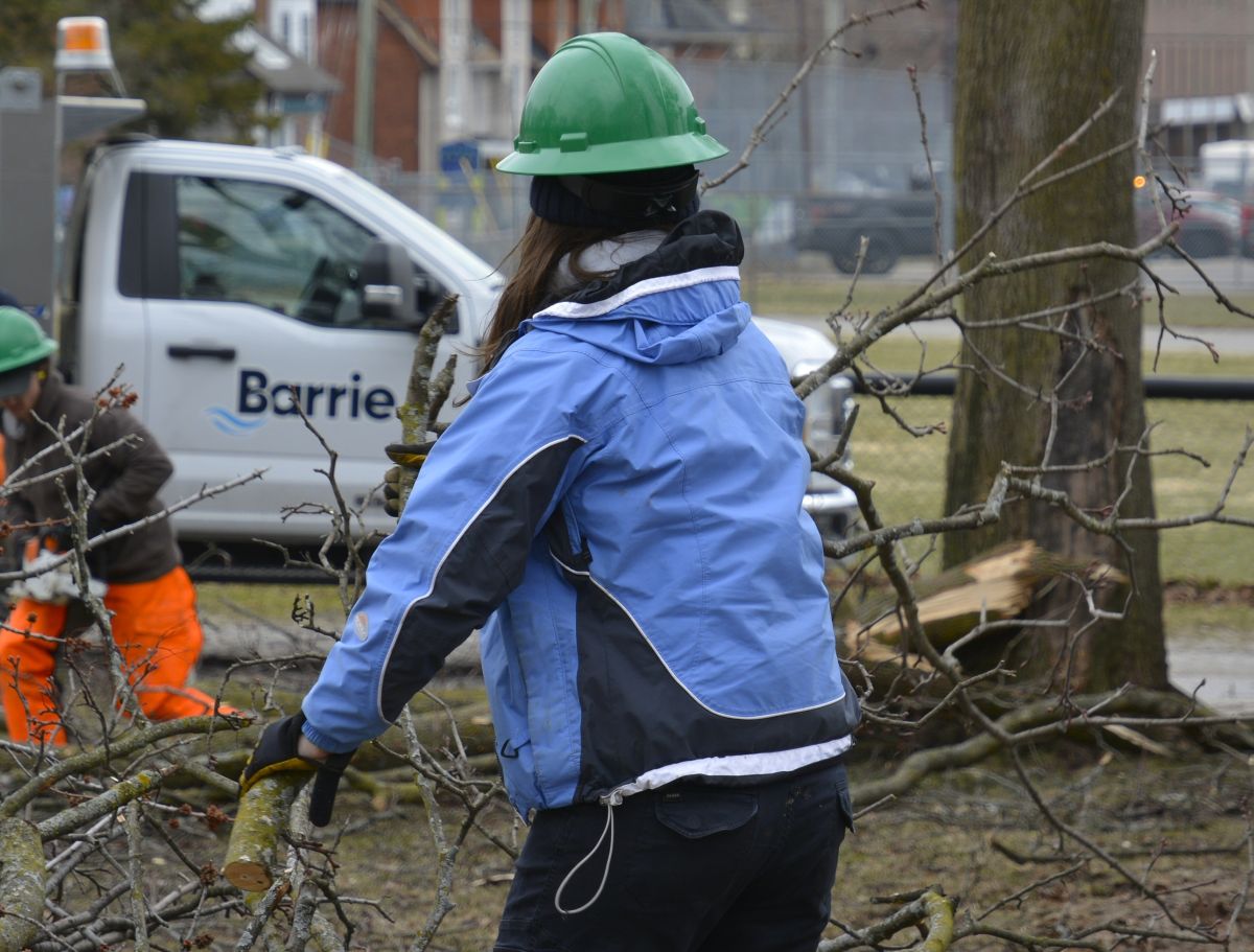 Crews cleaning up brush with City of Barrie truck on site