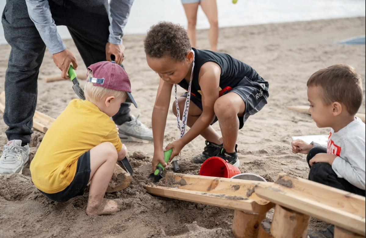 Kids playing with sand on the beach