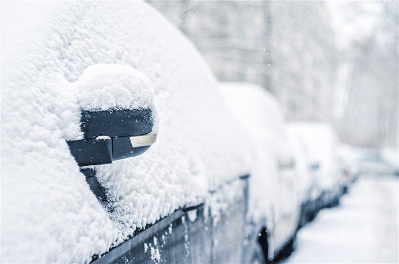 Parked cars covered in snow