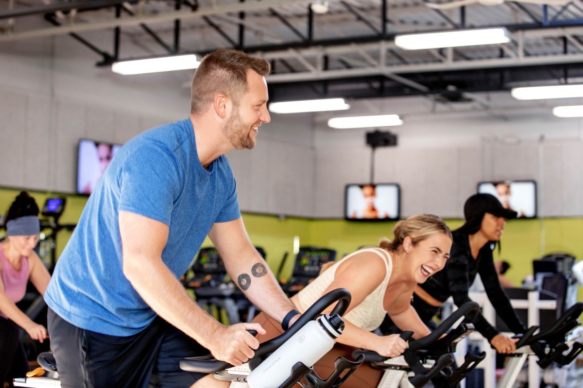 People riding stationary bikes