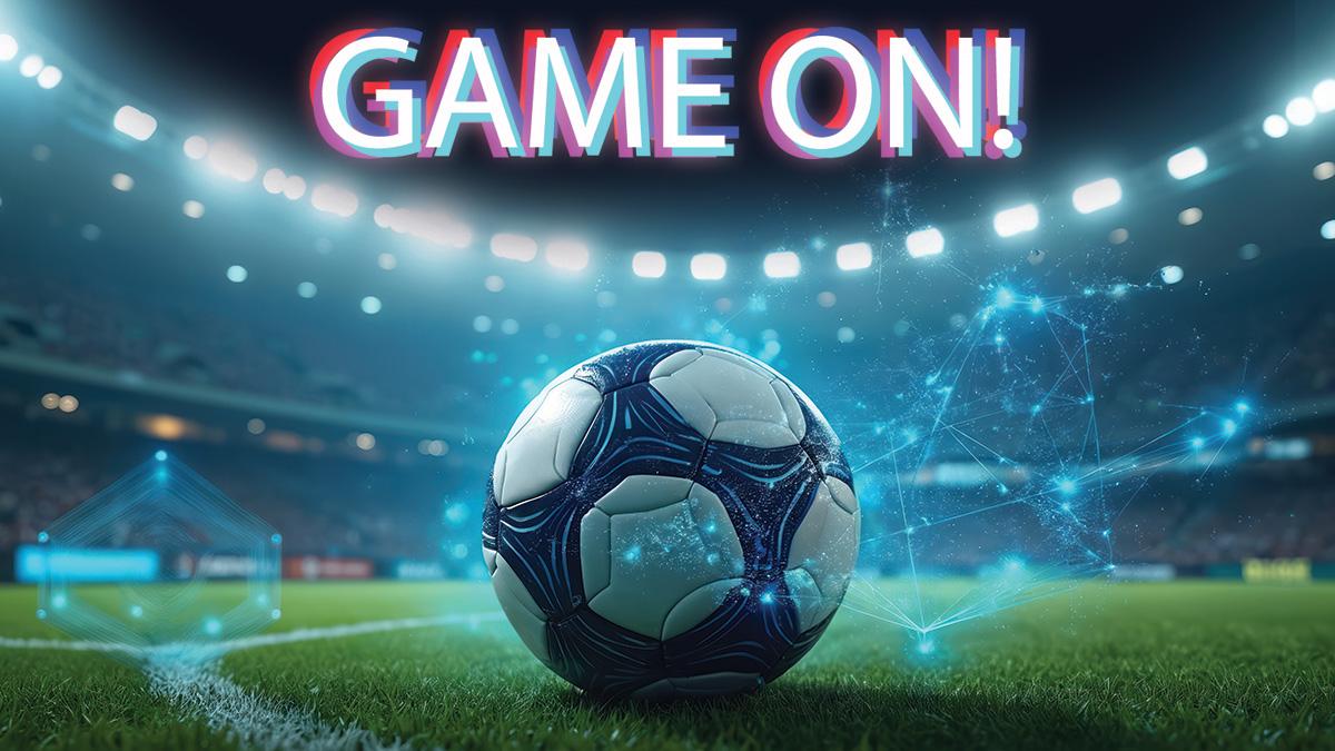 A soccer ball on a green field with stadium lights and "GAME ON!" text above.