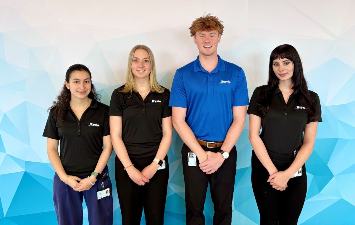 Four young people stand in a row, dressed in City of Barrie polo shirts.