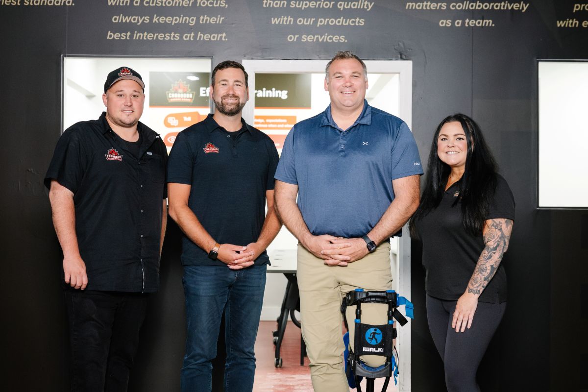 Four professionals smiling and posing for a photo.