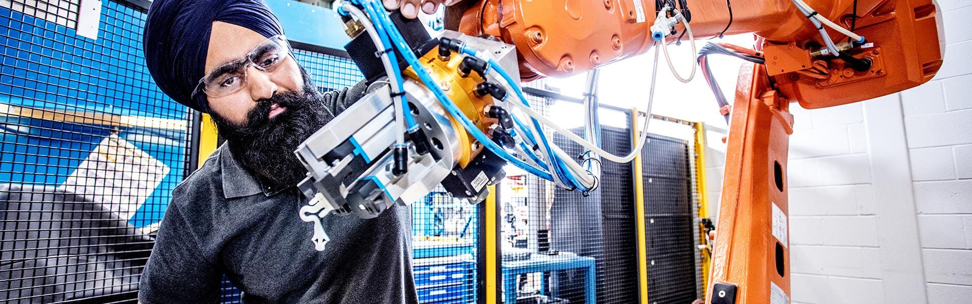 A man working on a robotic arm