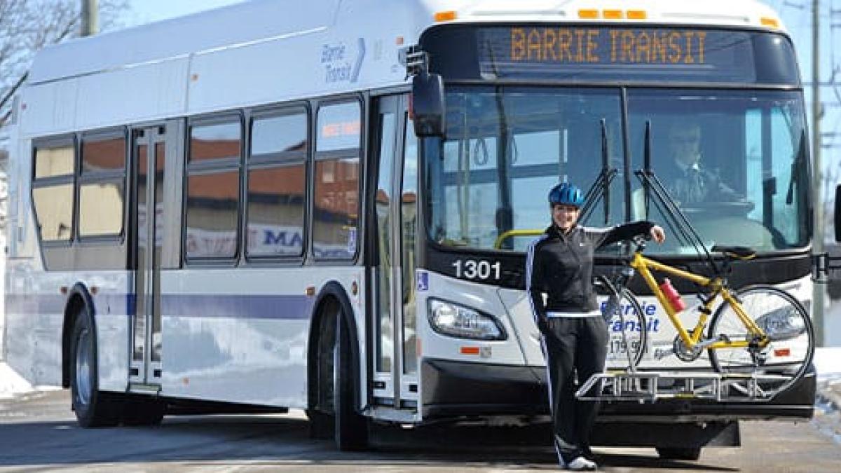 Barrie Transit bus with person standing in front and bike on rack