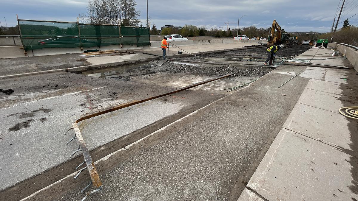 Workers removing east expansion joint