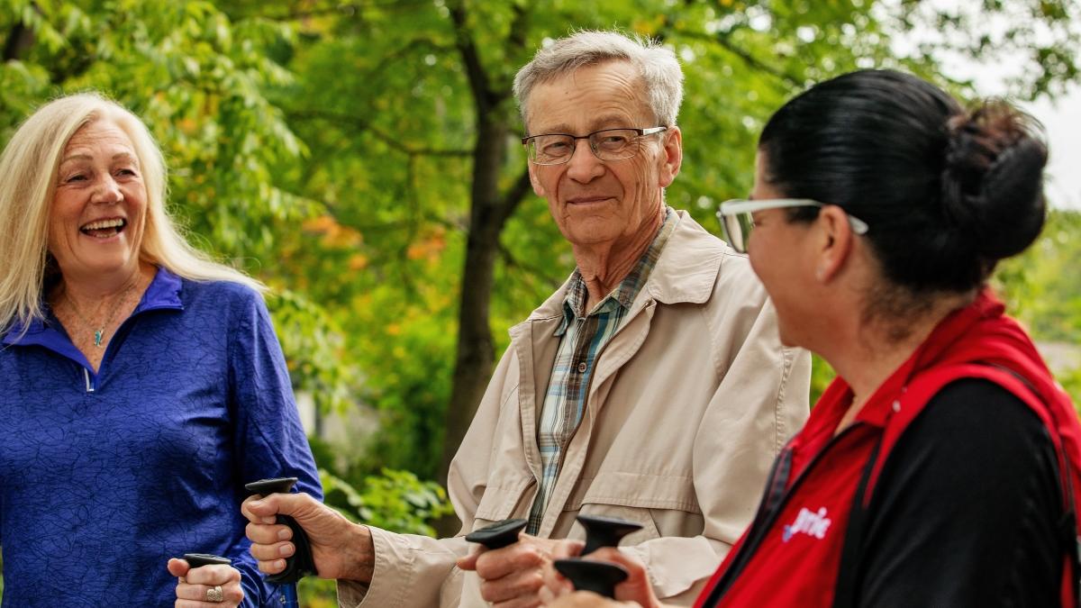 two seniors with a City of Barrie staff person