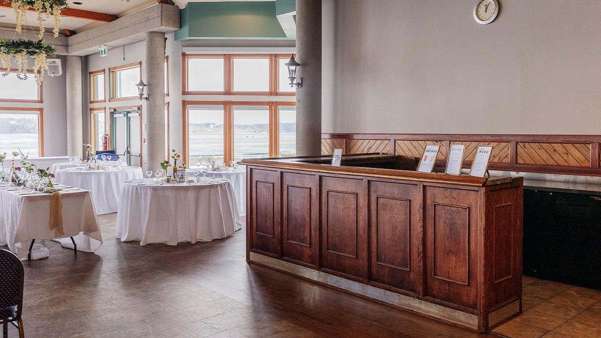Event setup with chairs and table, bar in foreground
