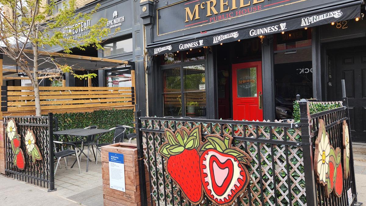 Colourful artwork of strawberries and flowers on the McReilly's patio fencing