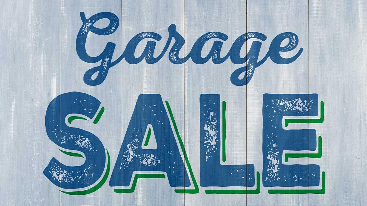 Grungy text on faded wood background: Garage SALE