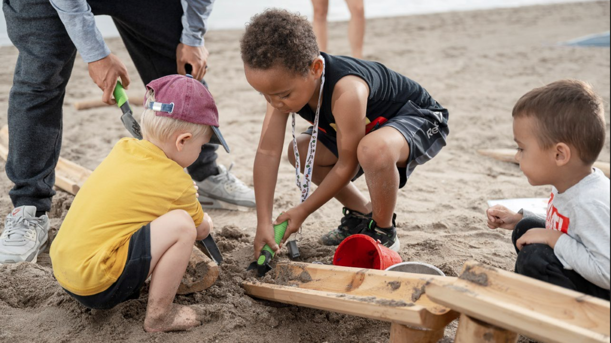 Kids playing with sand on the beach