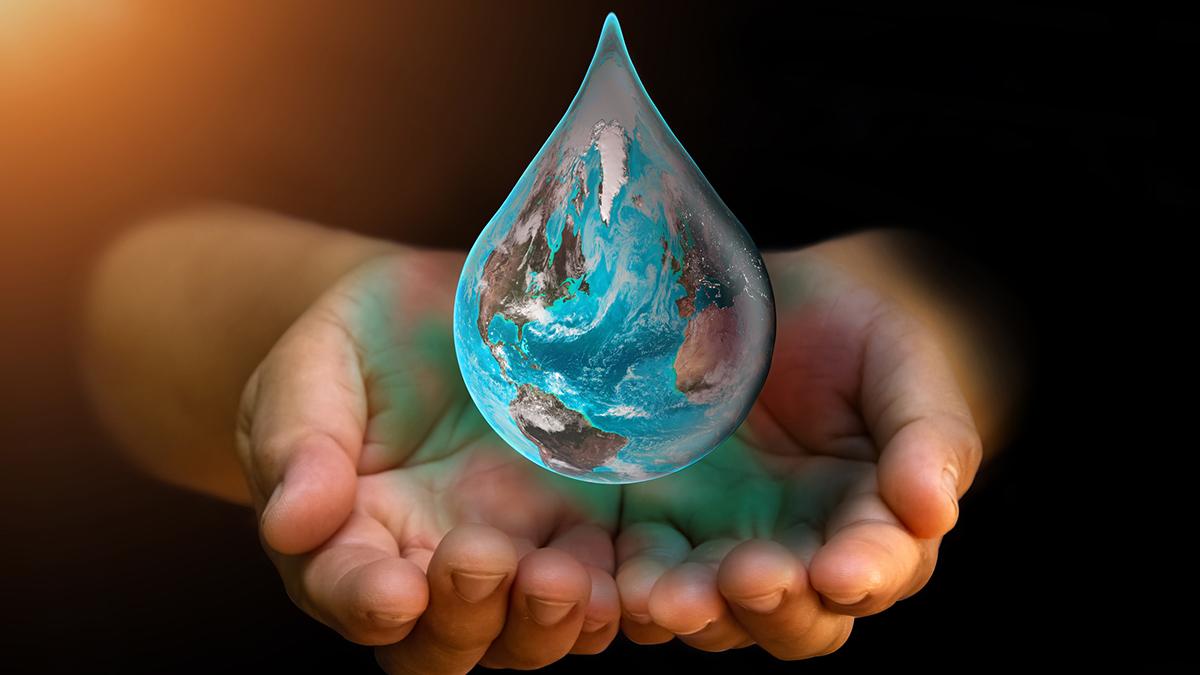 Hands holding a transparent water drop with a detailed depiction of Earth inside it, symbolizing environmental care.
