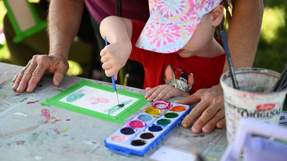 Child painting a Canada Flag