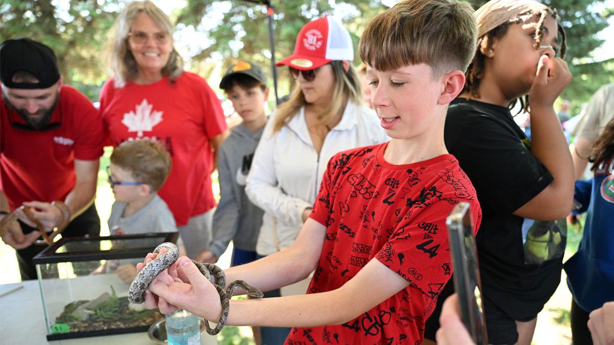 Kid holding a small snake