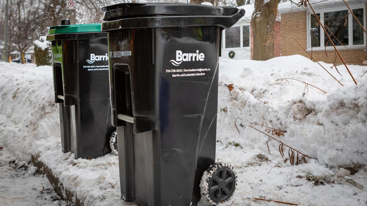 City of Barrie garbage and organics carts placed 2 feet apart on a cleared area at the curb.