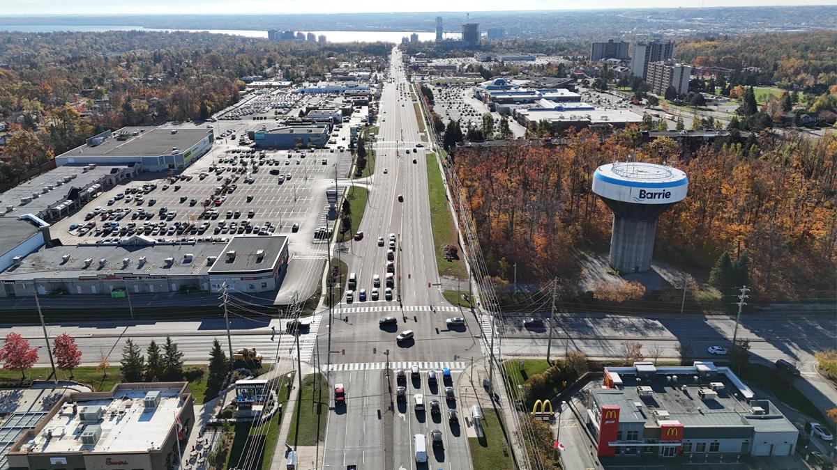 Aerial view of Bayfield Street in Barrie lined by large buildings and Barrie water tower.