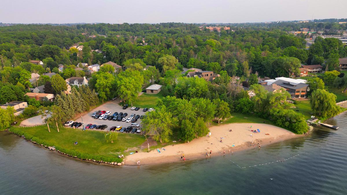 Aerial view of Minet's Point Park & Beach including a sandy beach area surrounded by greenery and residential buildings.