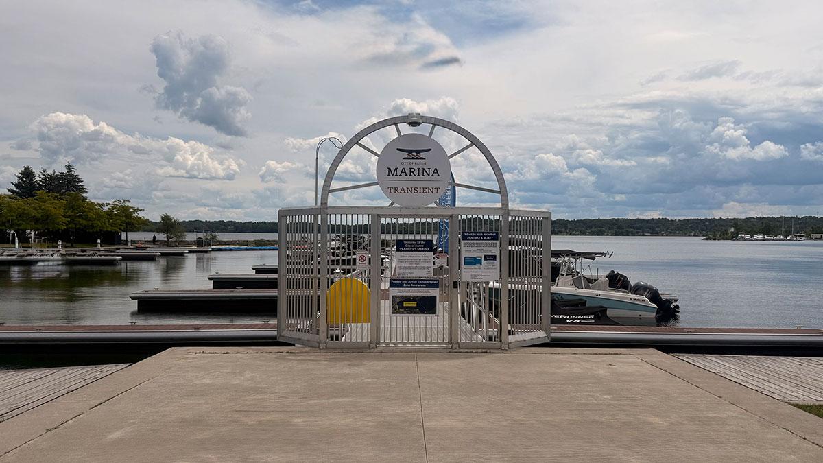 Entrance gate to a marina, with boats docked nearby.