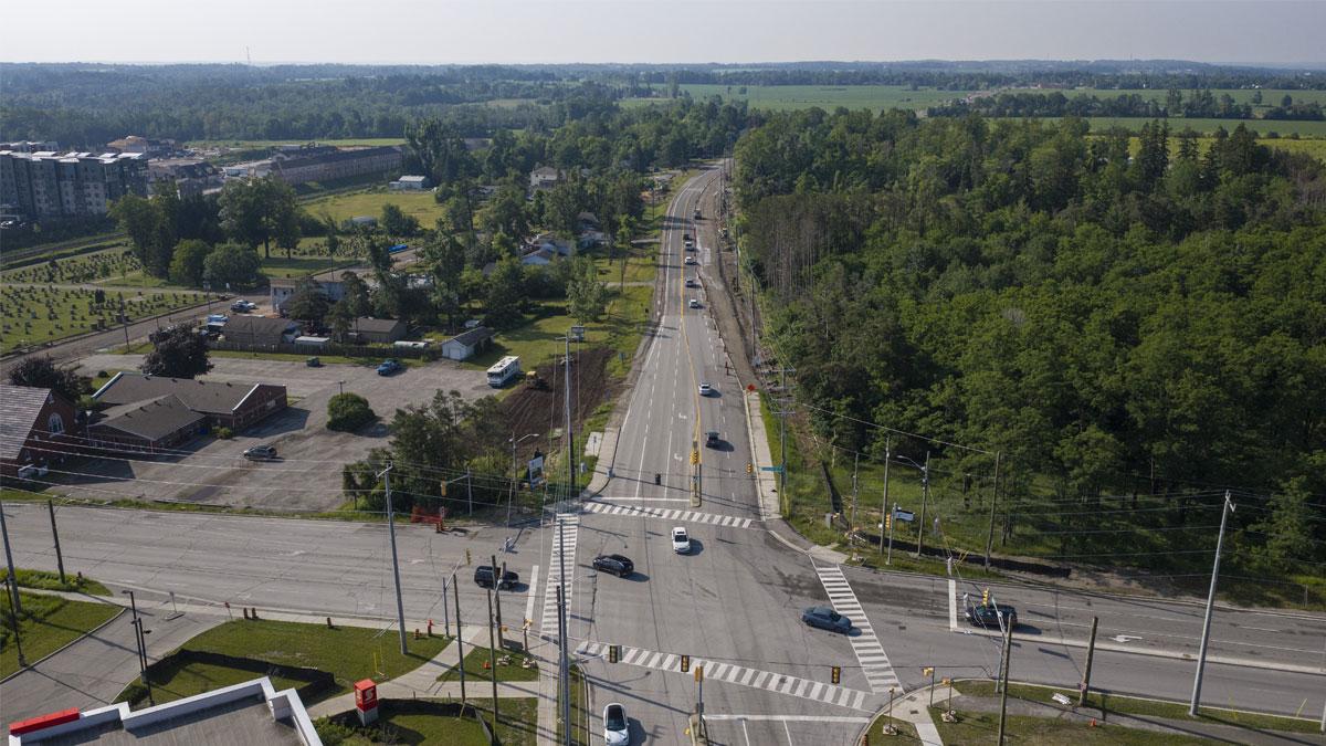 Aerial view of an intersection with the road in the background under construction.