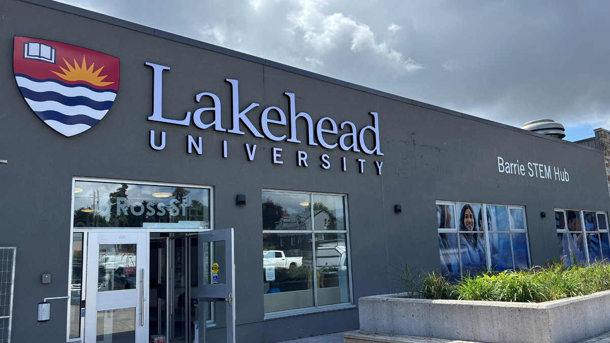 Exterior of Lakehead University building with logo and entrance.
