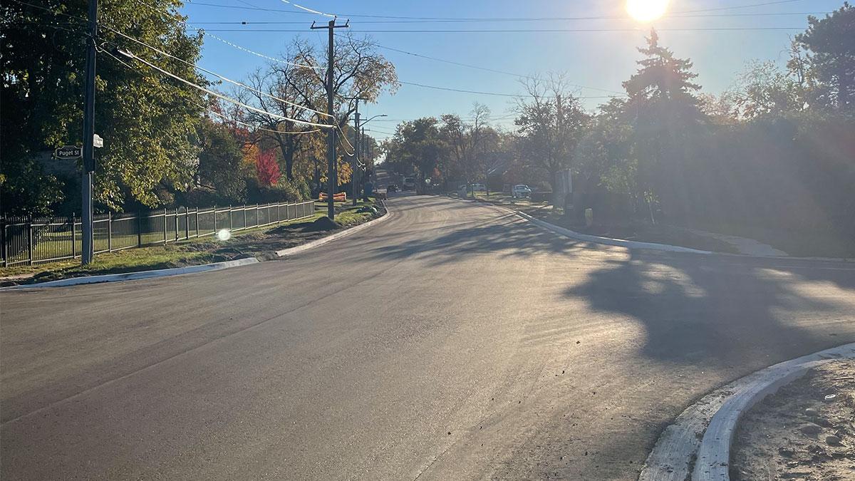 Freshly paved road with new concrete curbs. 