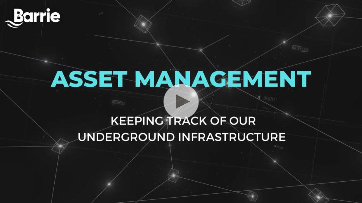 Promotional graphic from the City of Barrie featuring the text "Asset Management - Keeping track of our underground infrastructure" overlaid on a digital network of connecting lines and nodes, resembling a map or network diagram.