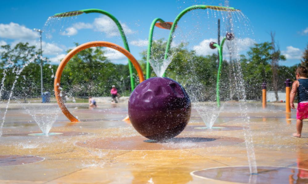 Boy and water at Lampman Lane Splash Pad