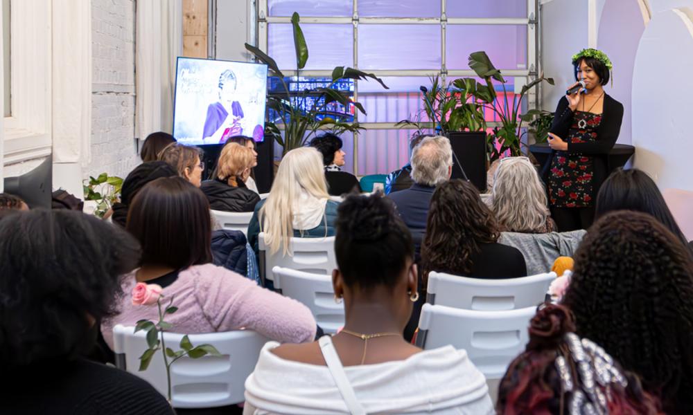 Tynesia Thomas speaks in front of a crowd at her event