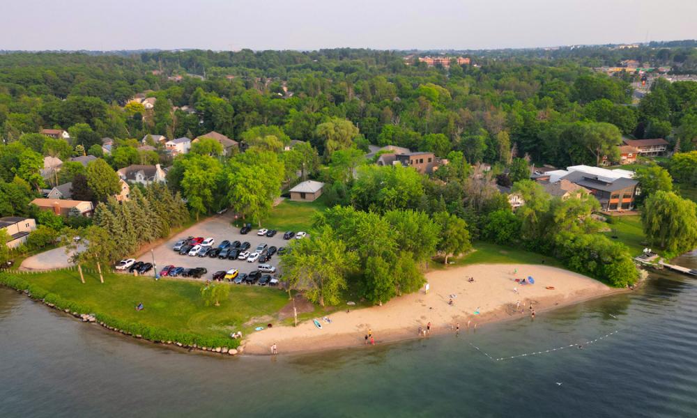 Aerial view of Minet's Point Park & Beach including a sandy beach area surrounded by greenery and residential buildings.
